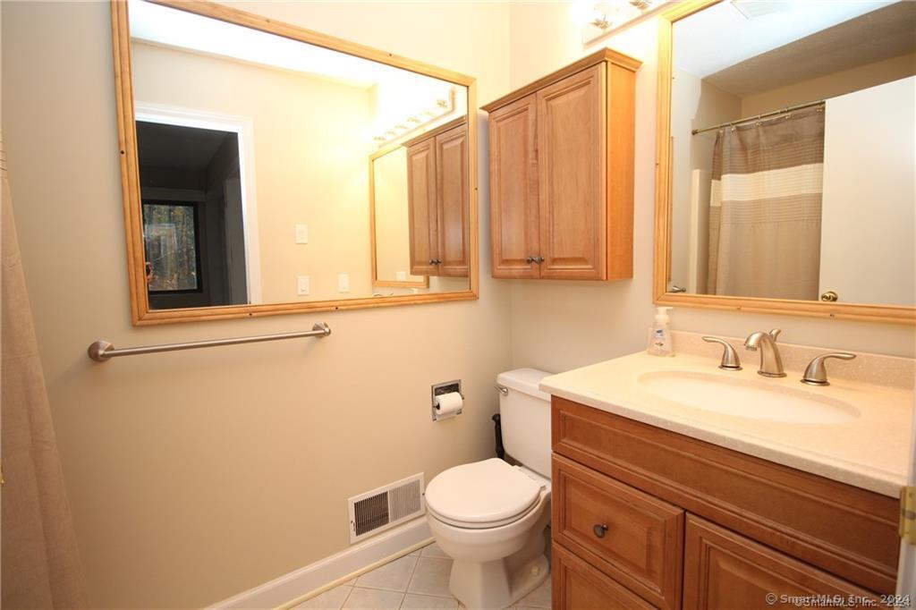 7 Woods Way, Unit 7 Woodbury, CT 06798 - Photo 13 of 19 a bathroom with a sink a toilet and a mirror