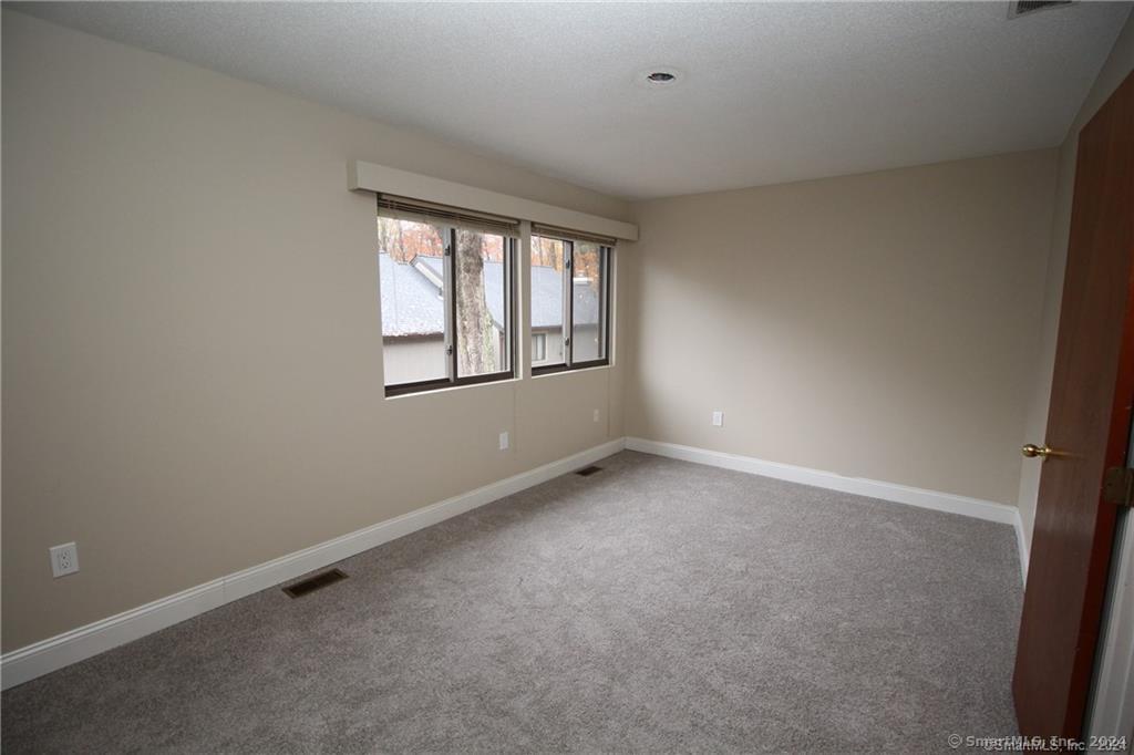7 Woods Way, Unit 7 Woodbury, CT 06798 - Photo 14 of 19 an empty room with a window