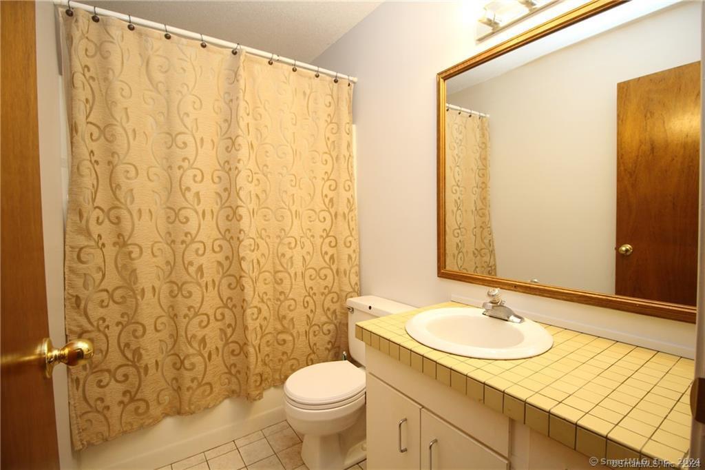 7 Woods Way, Unit 7 Woodbury, CT 06798 - Photo 15 of 19 a bathroom with a sink and a mirror