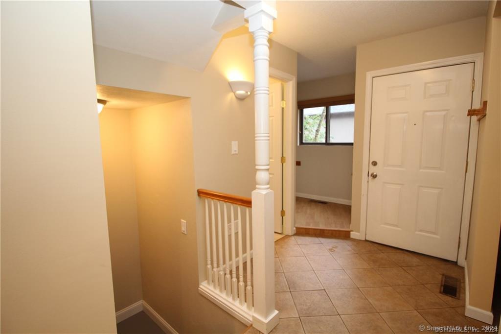 7 Woods Way, Unit 7 Woodbury, CT 06798 - Photo 4 of 19 a view of a hallway with wooden floor and a bathroom