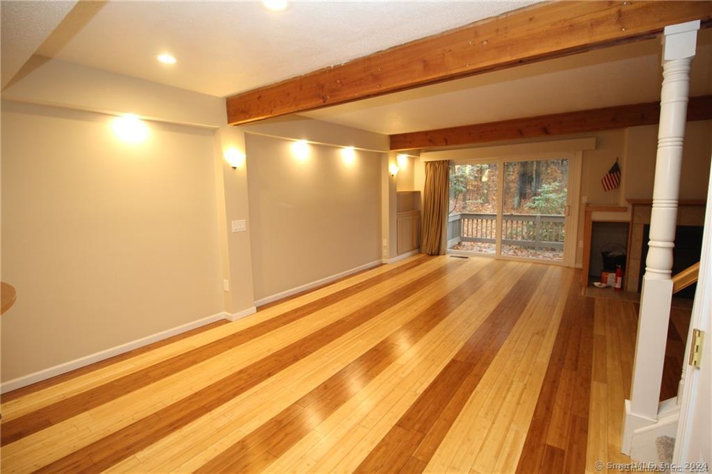 7 Woods Way, Unit 7 Woodbury, CT 06798 - Photo 8 of 19 a view of an empty room with wooden floor and a window