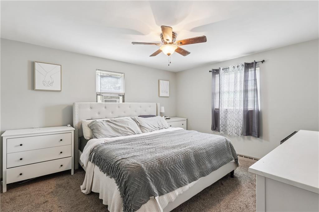 550 McClane Farm Road Washington, PA 15301 - Photo 22 of 31 a bedroom with a large bed and a chandelier