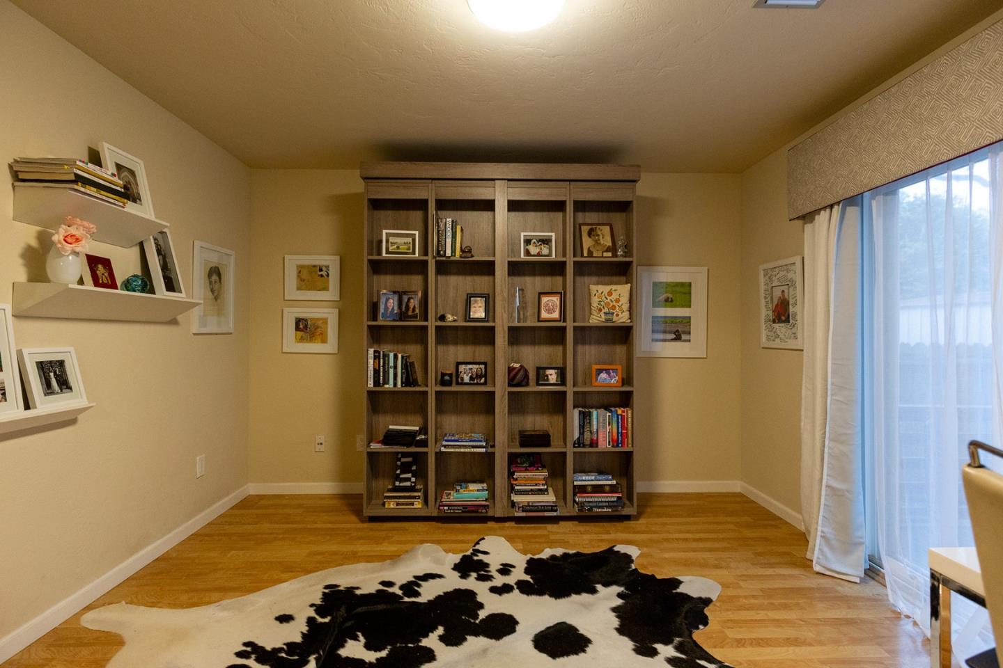 779 Alice Street Monterey, CA 93940 - Photo 15 of 27 a room with a bookshelf and a window