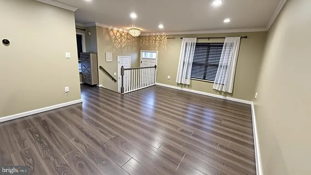 an entryway of a house with wooden floor