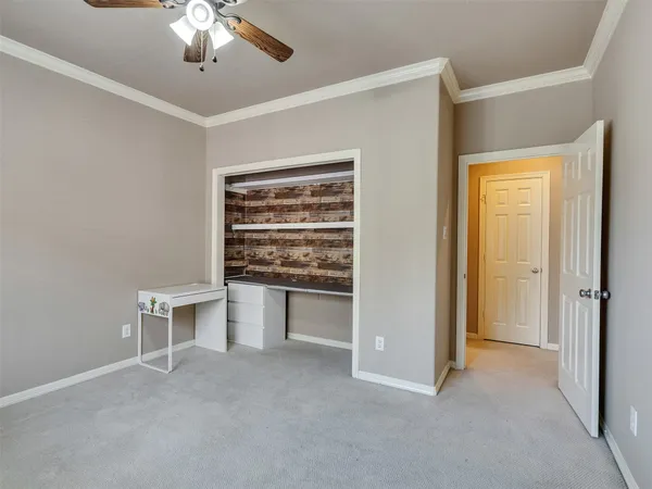 a view of an empty room with a ceiling fan