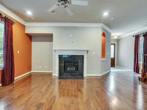 wooden floor in an empty room with a window