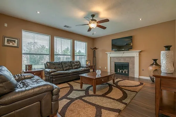 a living room with furniture a flat screen tv and a fireplace