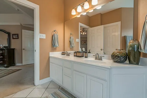 a bathroom with a double vanity sink and a mirror