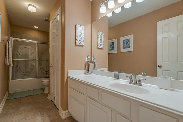 a bathroom with a sink a mirror and a shower