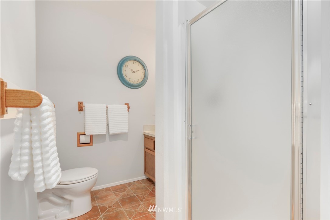 17830 28th Avenue Southeast Bothell, WA 98012 - Photo 14 of 25 a white toilet sitting next to a shower curtain
