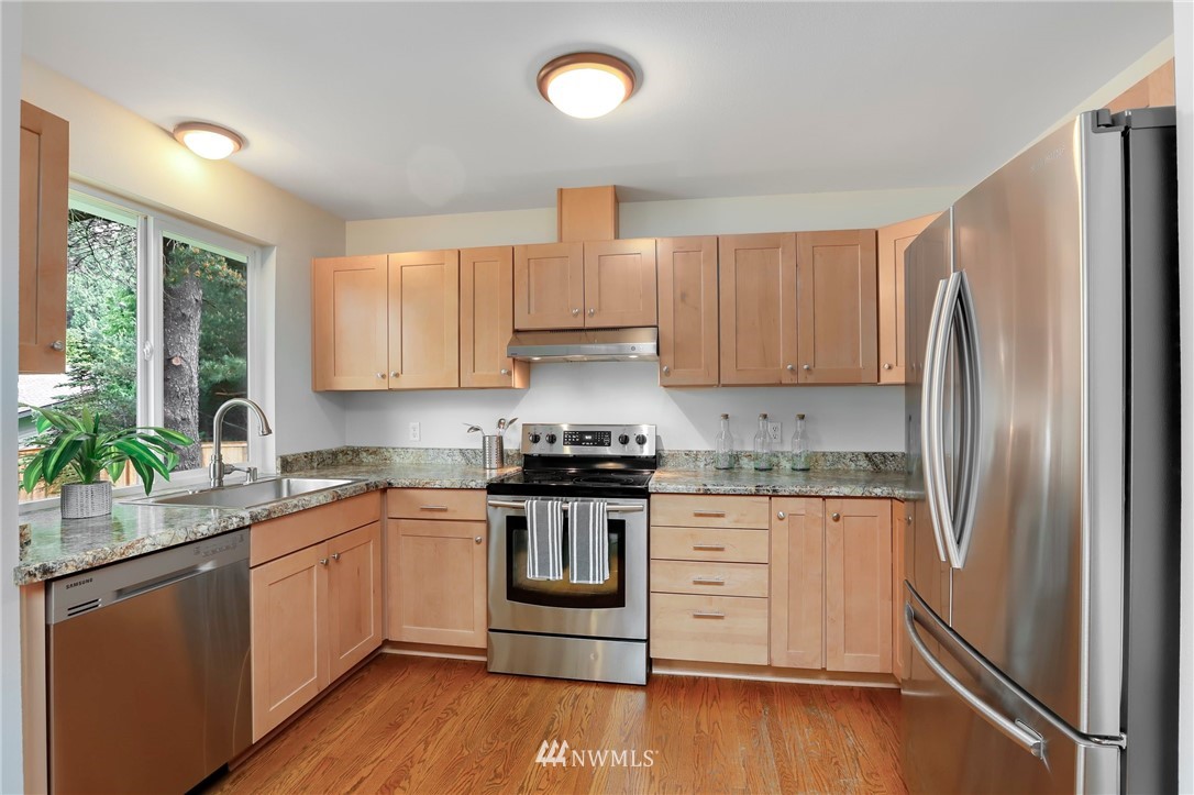 17830 28th Avenue Southeast Bothell, WA 98012 - Photo 6 of 25 a kitchen with granite countertop a refrigerator stove and sink