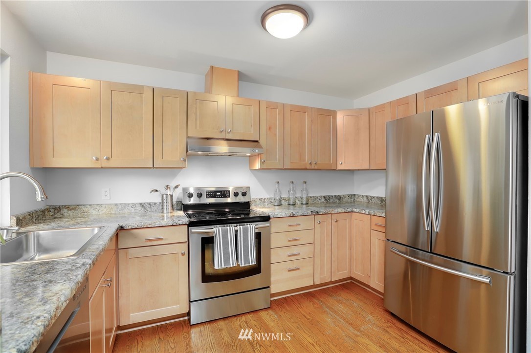 17830 28th Avenue Southeast Bothell, WA 98012 - Photo 7 of 25 a kitchen with a refrigerator sink and cabinets