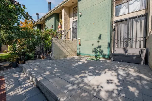 a view of a house with backyard and sitting area