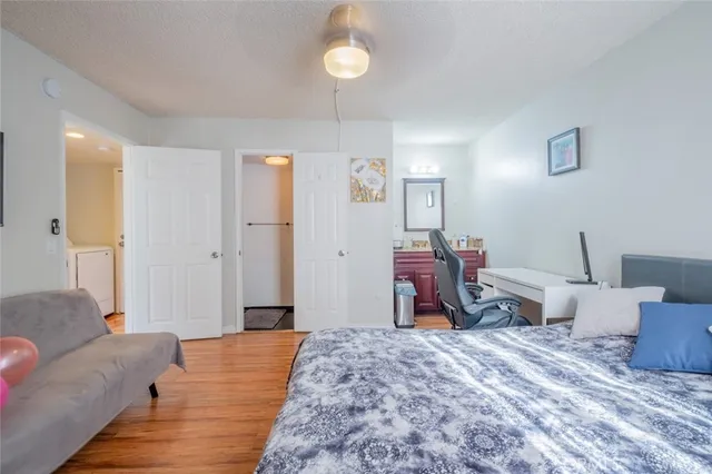 a bed room with a bed and a chair