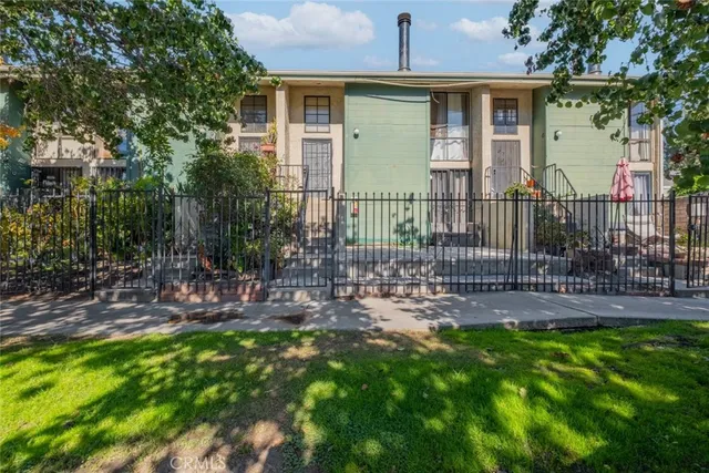 a view of a house with a yard and sitting area