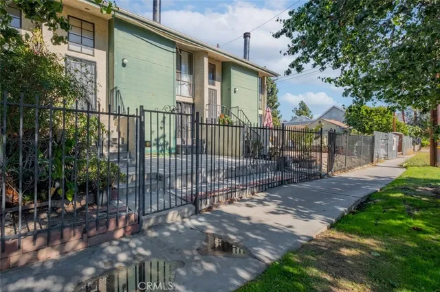 a view of a wrought iron fences in front of house