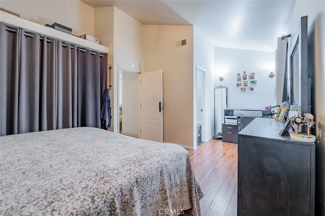 a bedroom with a bed dresser and a large mirror