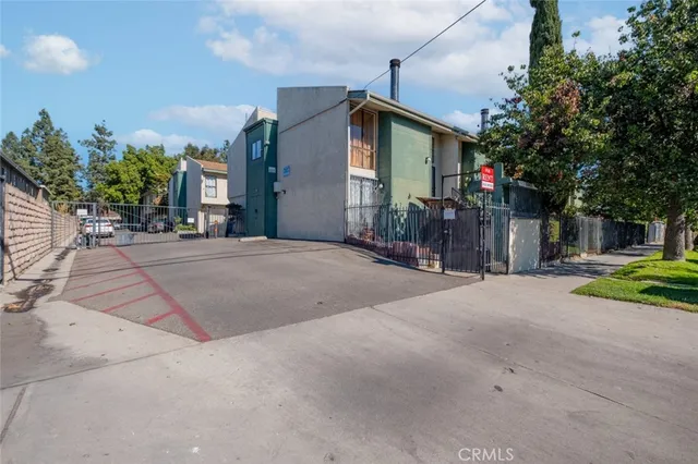 a front view of a house with a yard and potted plants