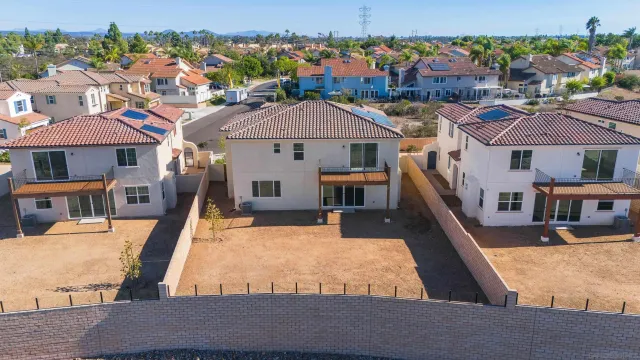 an aerial view of a house with swimming pool and outdoor seating
