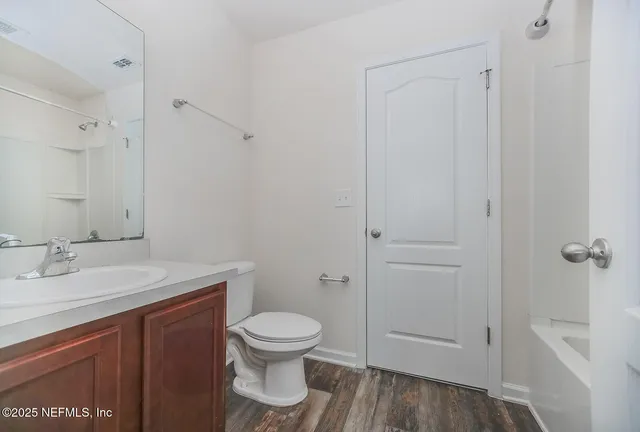 a white toilet sitting next to a bathroom sink