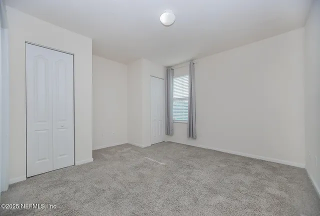 a view of an empty room and entryway