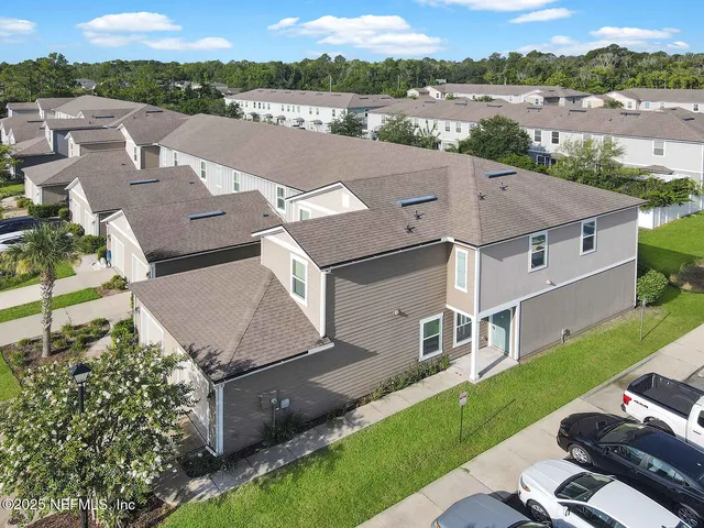 an aerial view of a house with pool a yard and outdoor seating
