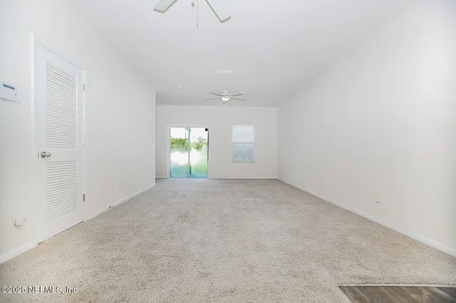 an empty room with window and pillar in it