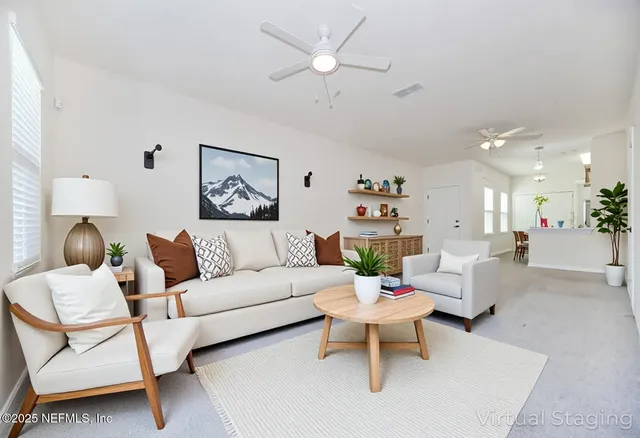 a living room with furniture and a chandelier