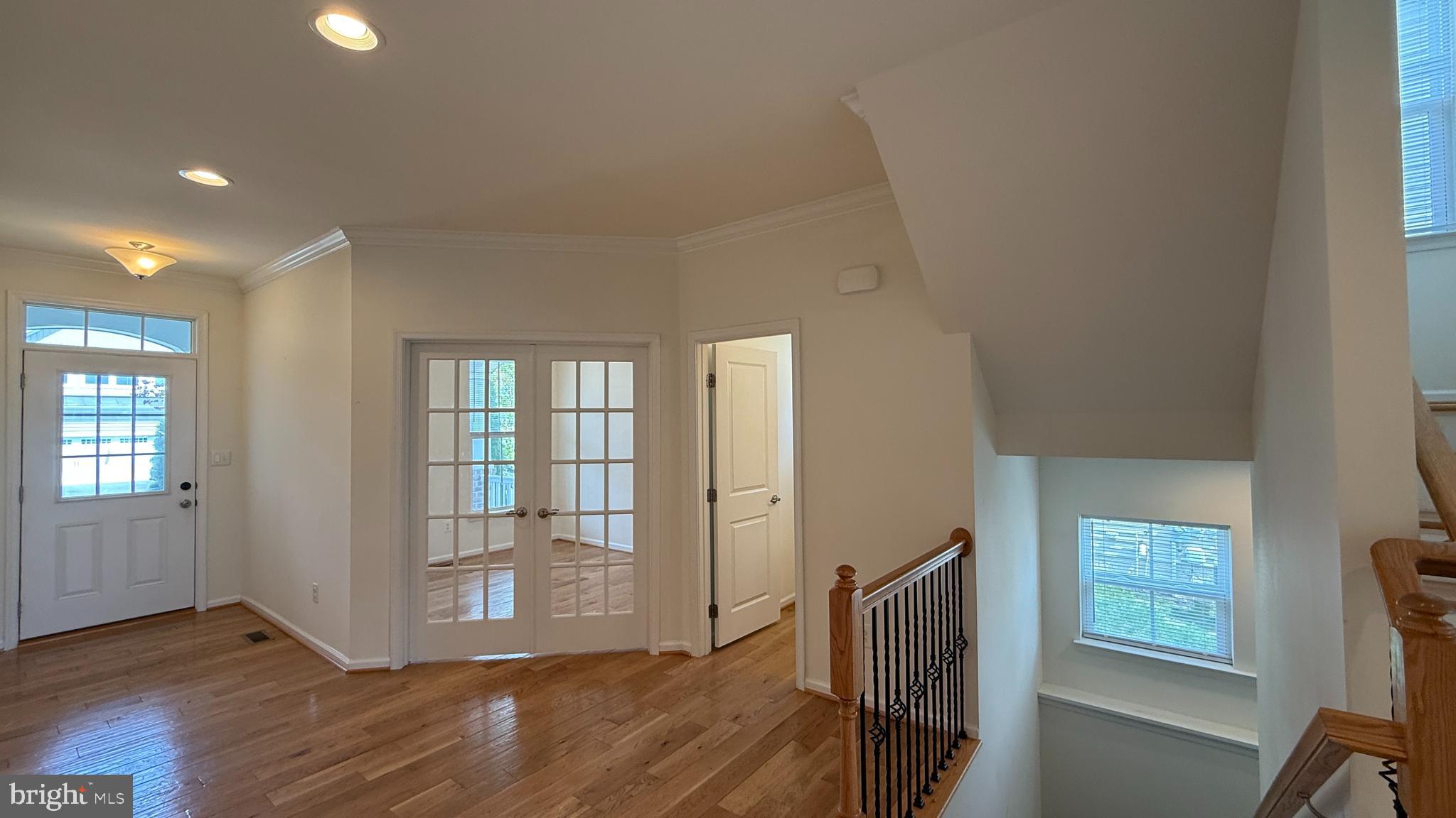 12421 Mays Quarter Road Woodbridge, VA 22192 - Photo 11 of 30 a view of an empty room with wooden floor and a window