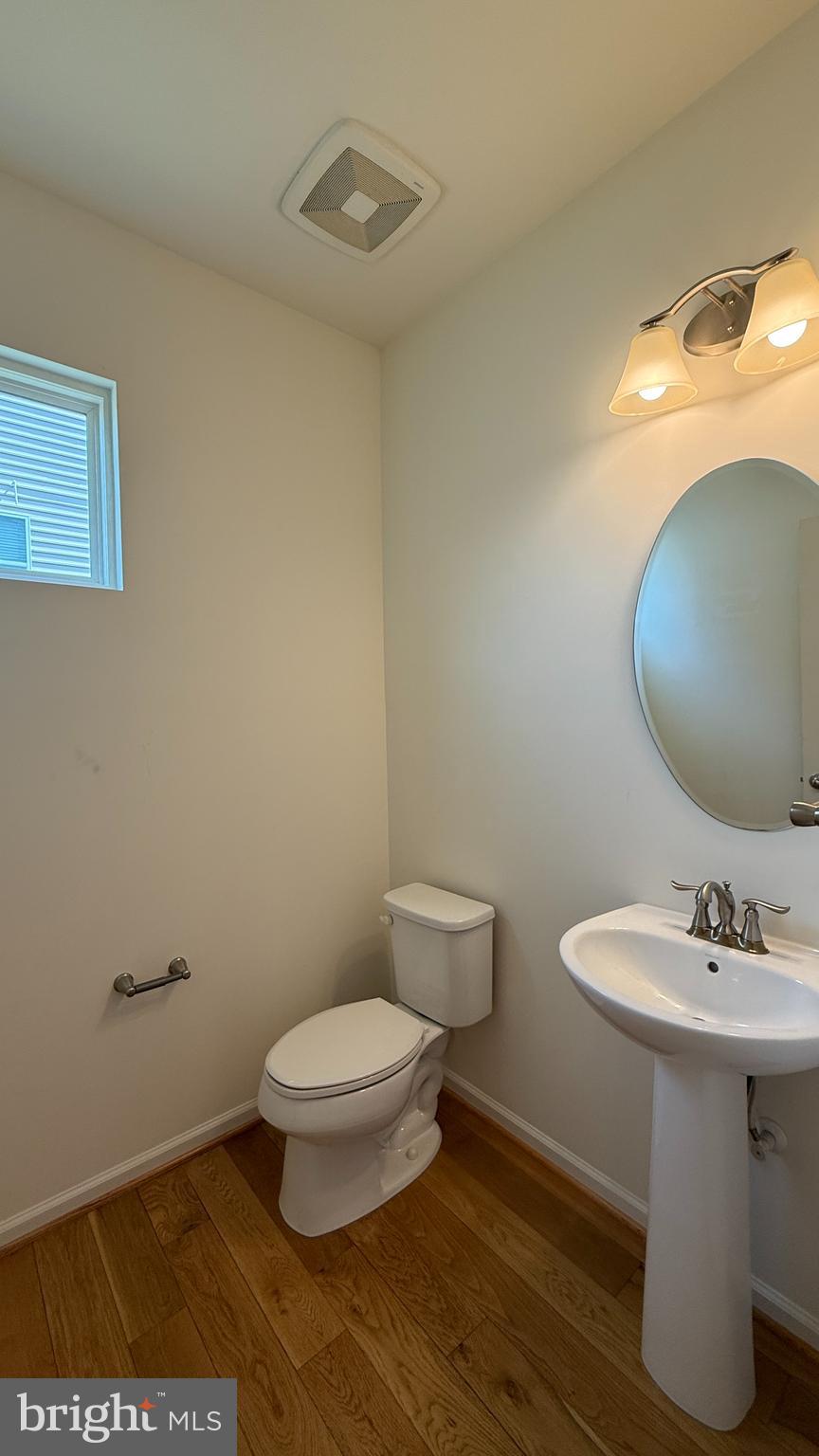 12421 Mays Quarter Road Woodbridge, VA 22192 - Photo 13 of 30 a bathroom with a sink a toilet and mirror