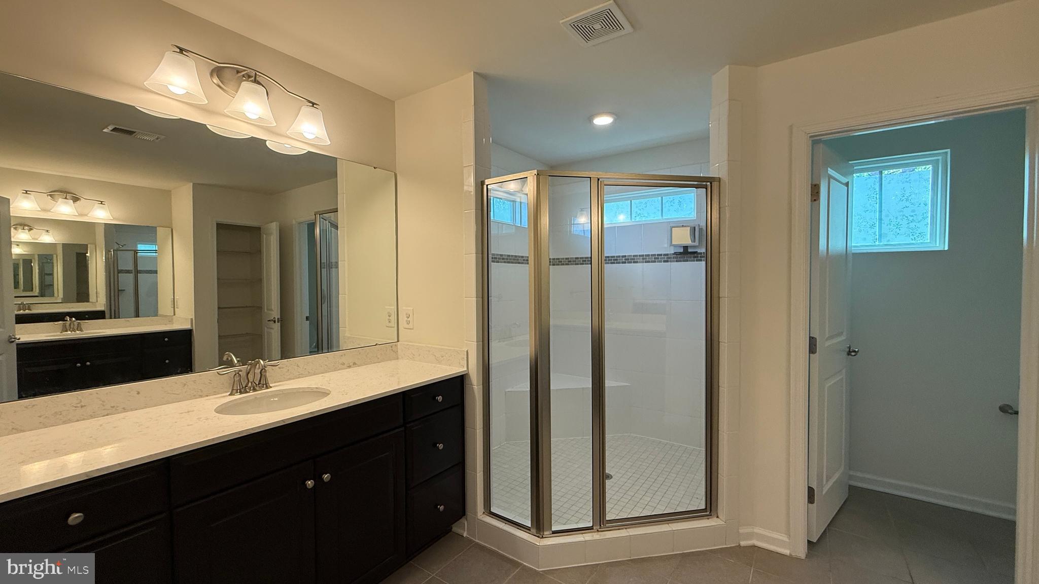 12421 Mays Quarter Road Woodbridge, VA 22192 - Photo 16 of 30 a bathroom with a double vanity sink and a mirror
