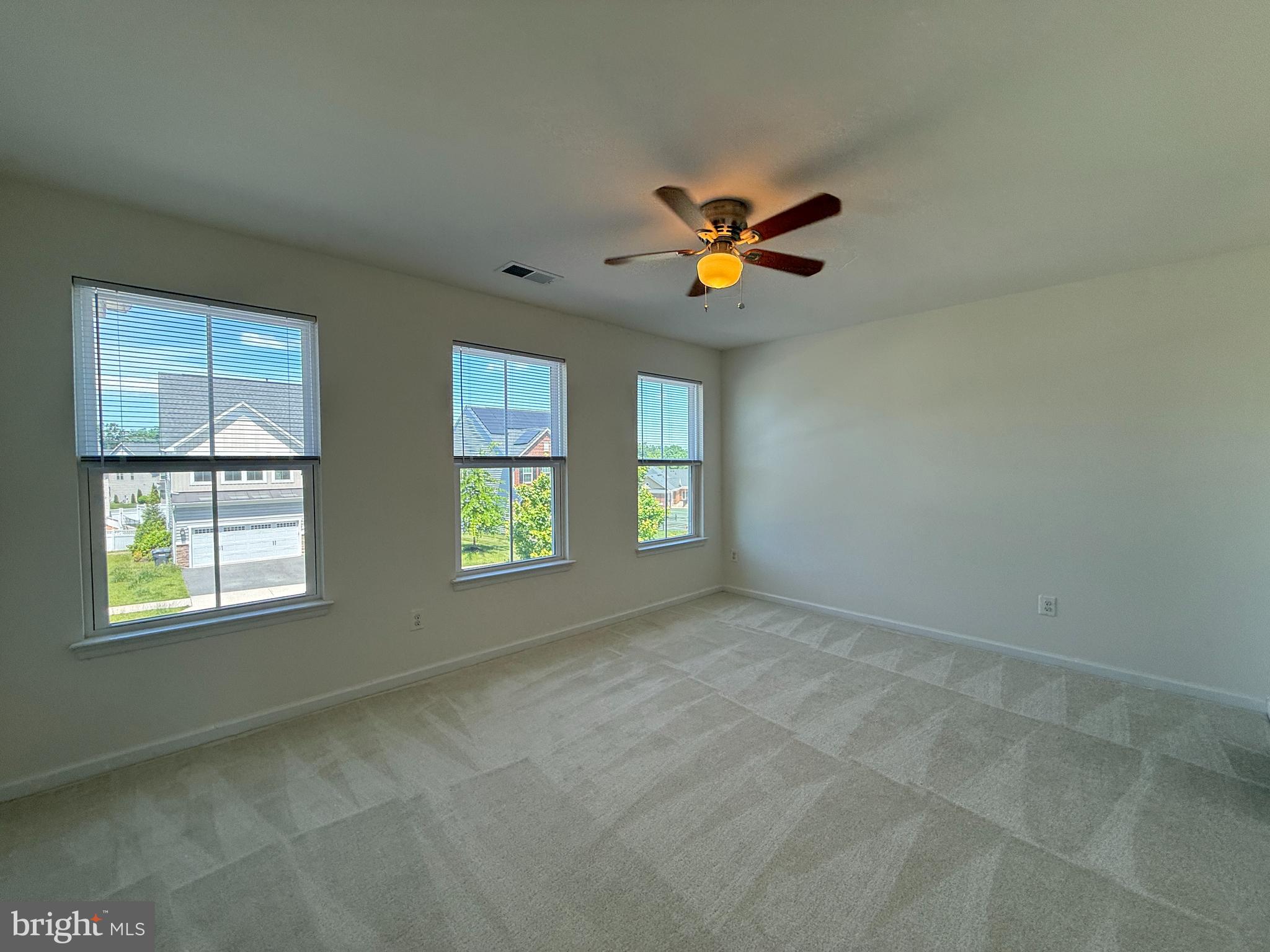 12421 Mays Quarter Road Woodbridge, VA 22192 - Photo 19 of 30 an empty room with windows and ceiling fan view