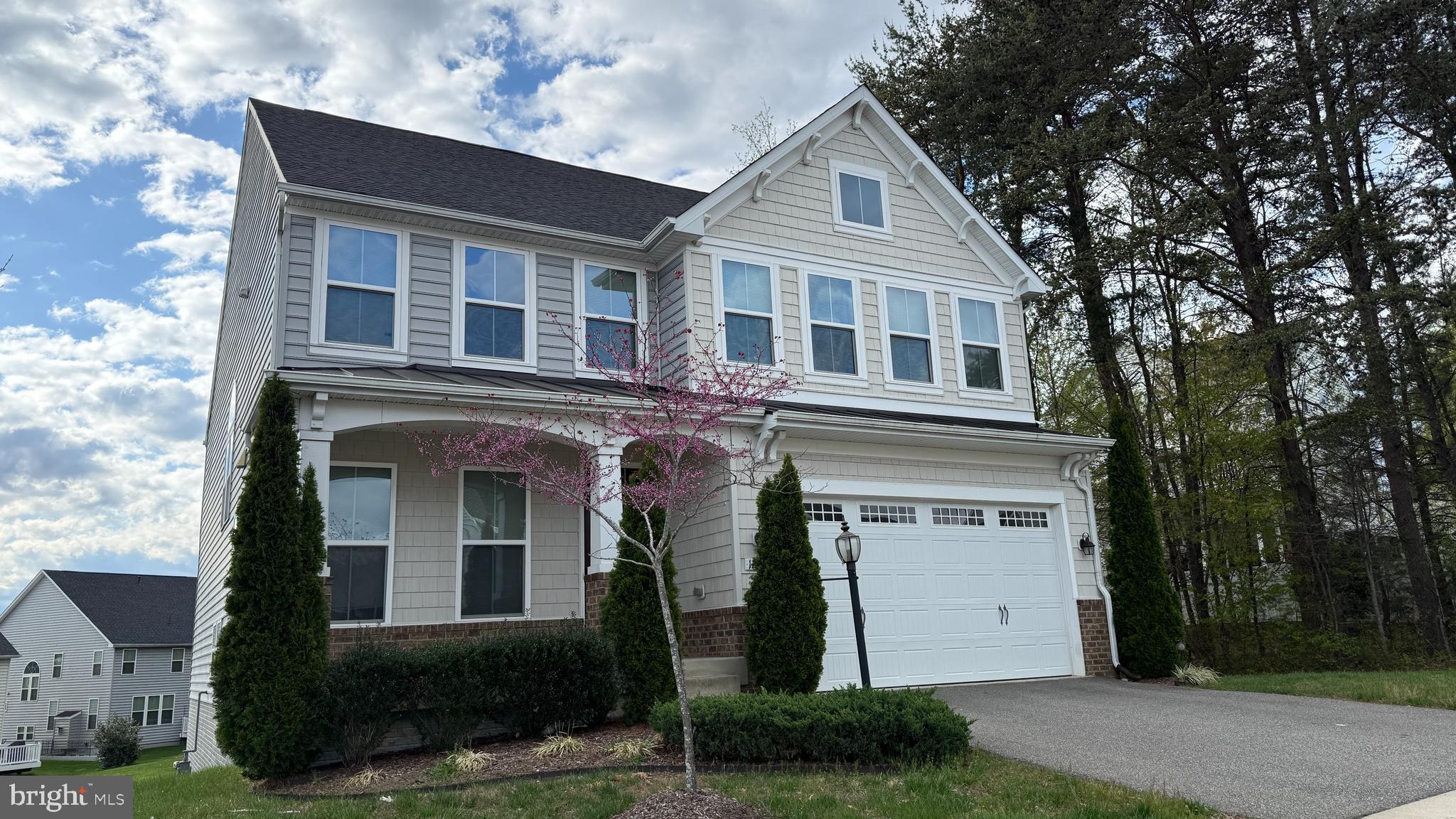 12421 Mays Quarter Road Woodbridge, VA 22192 - Photo 2 of 30 a front view of a house with a yard and garage