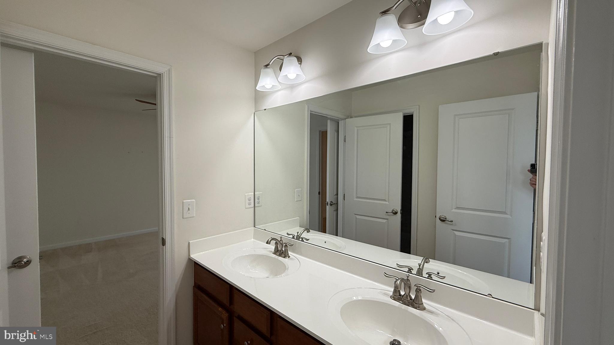 12421 Mays Quarter Road Woodbridge, VA 22192 - Photo 21 of 30 a bathroom with a sink double vanity and a mirror