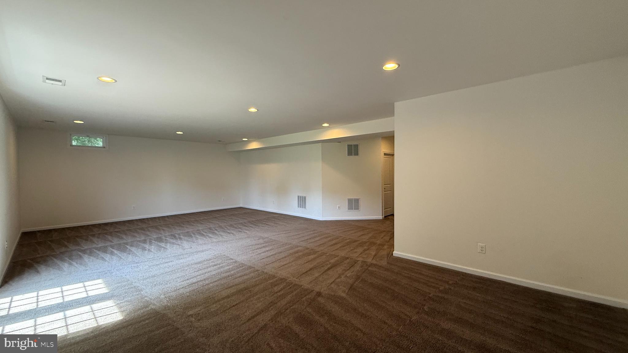 12421 Mays Quarter Road Woodbridge, VA 22192 - Photo 24 of 30 an empty room with wooden floor and windows