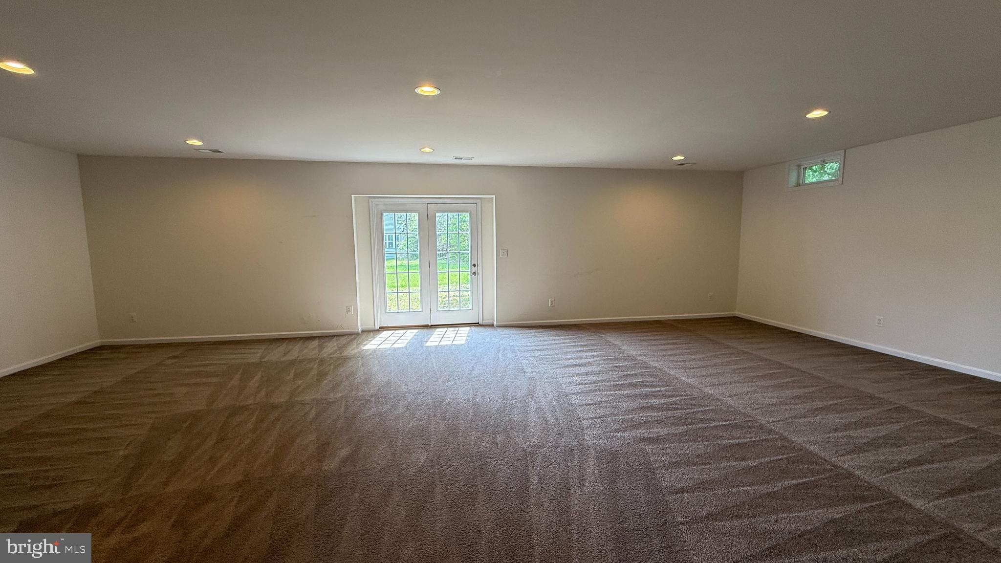 12421 Mays Quarter Road Woodbridge, VA 22192 - Photo 28 of 30 an empty room with wooden floor and windows