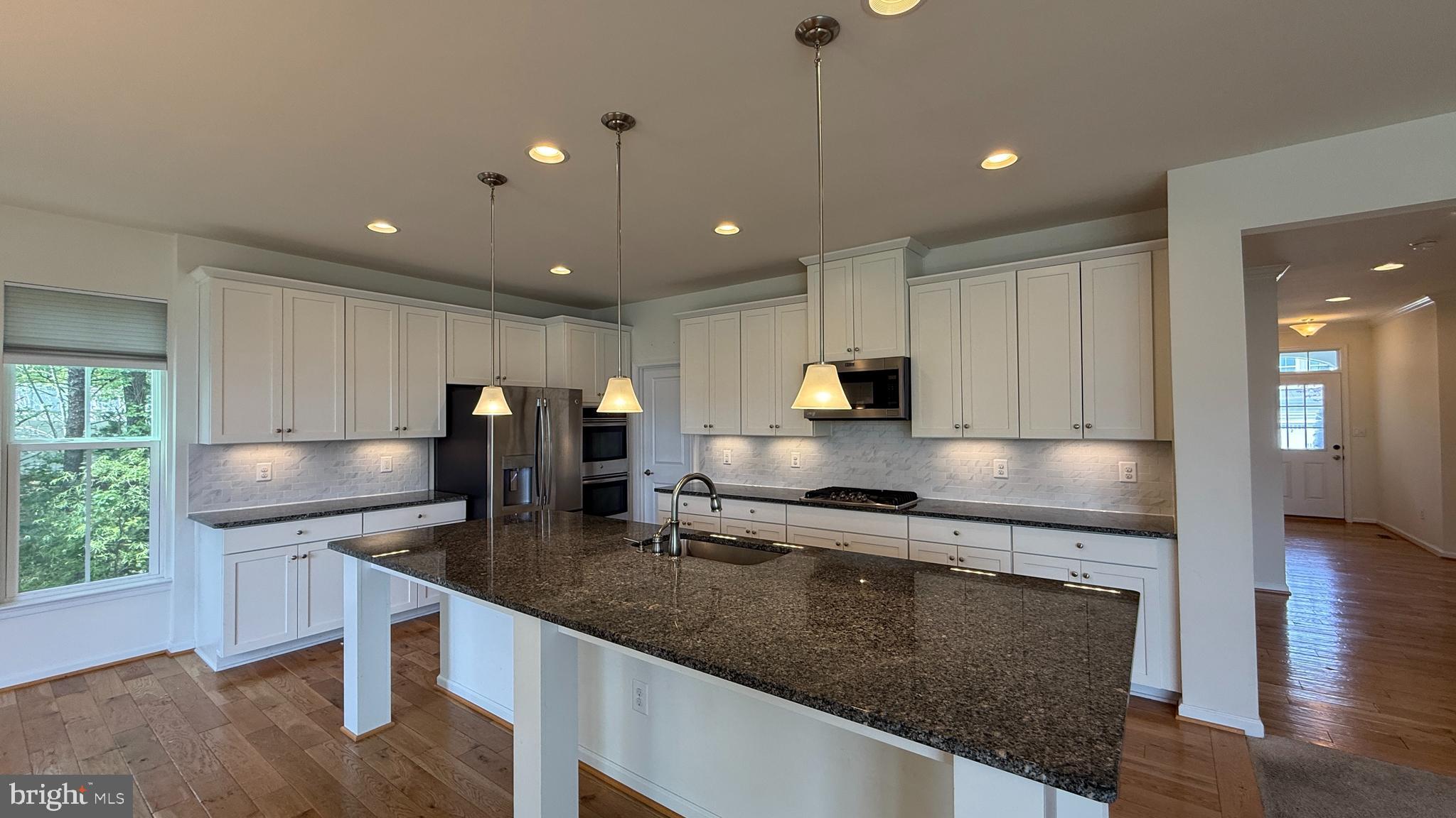 12421 Mays Quarter Road Woodbridge, VA 22192 - Photo 4 of 30 a large kitchen with granite countertop lots of counter space and window