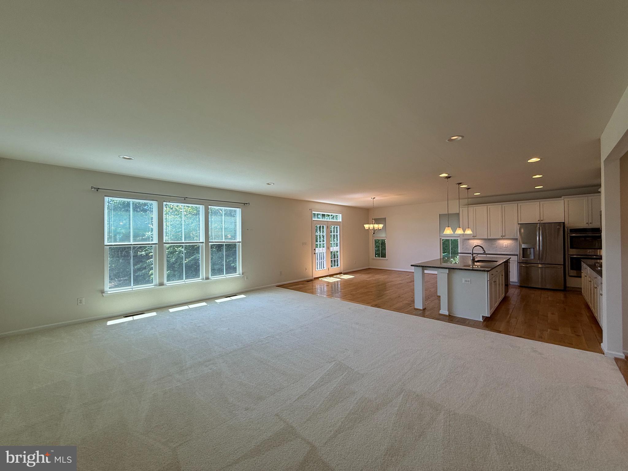 12421 Mays Quarter Road Woodbridge, VA 22192 - Photo 7 of 30 a view of an empty room with kitchen and window