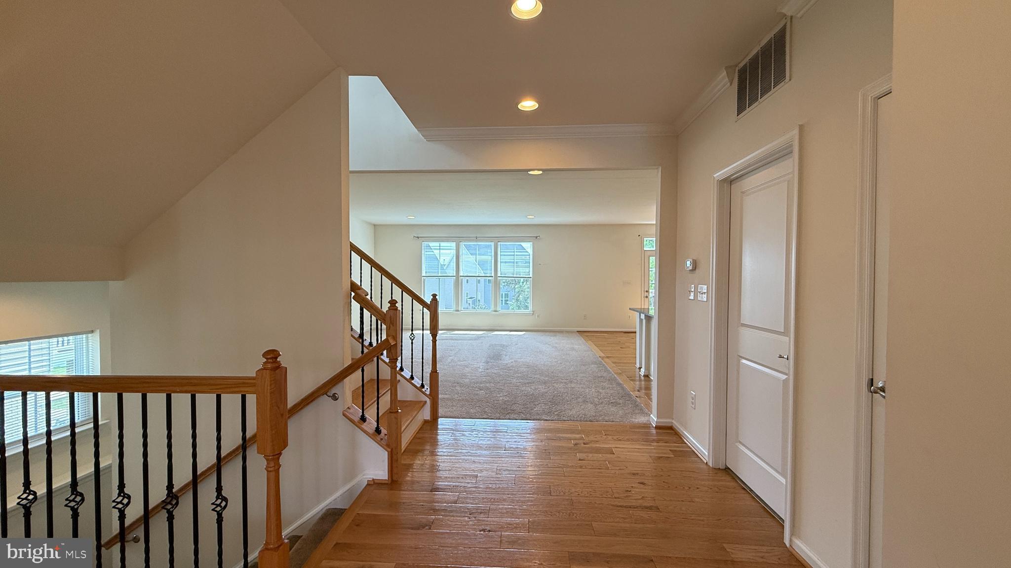 12421 Mays Quarter Road Woodbridge, VA 22192 - Photo 10 of 30 a view of a hallway with wooden floor and stairs