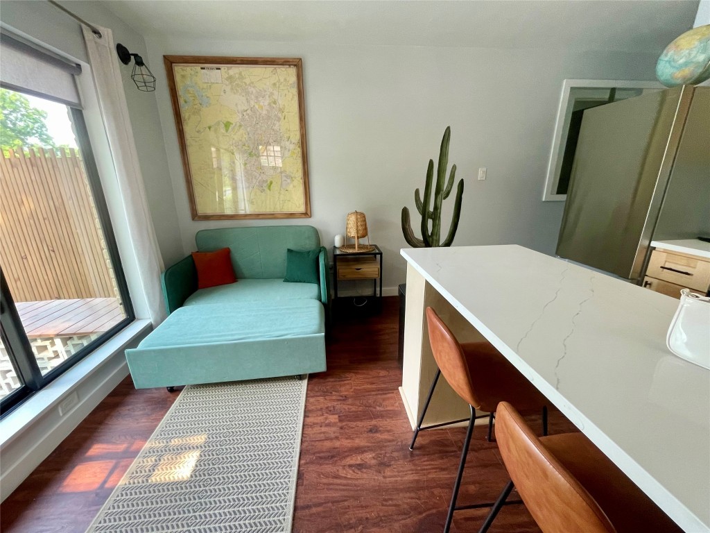 1023 Nile Street, Unit B Austin, TX 78702 - Photo 6 of 14 Living room with chair that opens to a twin sized bed.