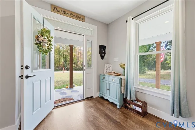 a view of an entryway with wooden floor and windows