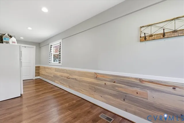 a view of storage and utility room with wooden floor