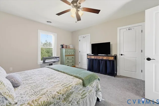 a bedroom with a large bed and a flat screen tv