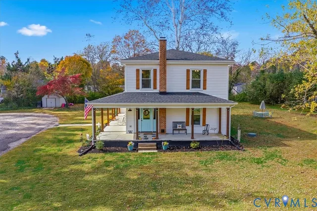a view of a house with a yard porch and sitting area