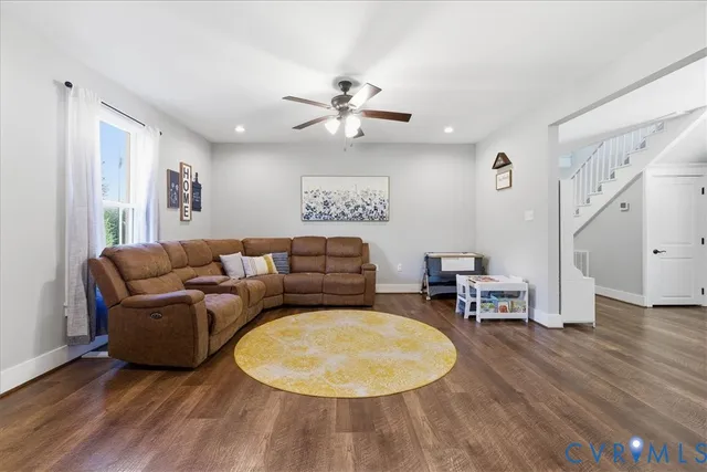 a living room with furniture and wooden floor