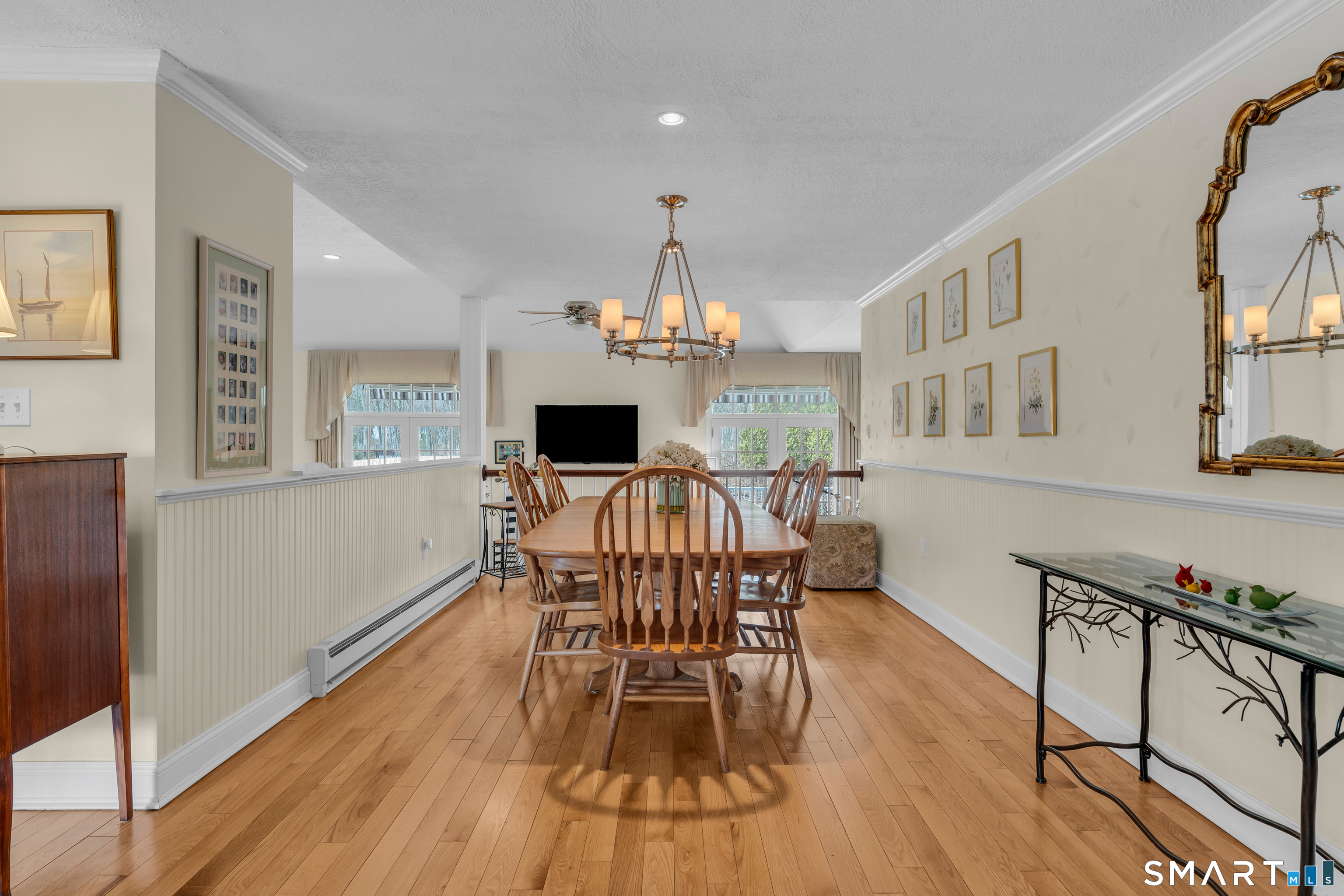 110 Nut Plains Road Guilford, CT 06437 - Photo 13 of 40 Dinner parties with a view. The gracious dining room with beadboard charm and classic wainscoting overlooks the family room below, keeping conversation flowing between spaces.