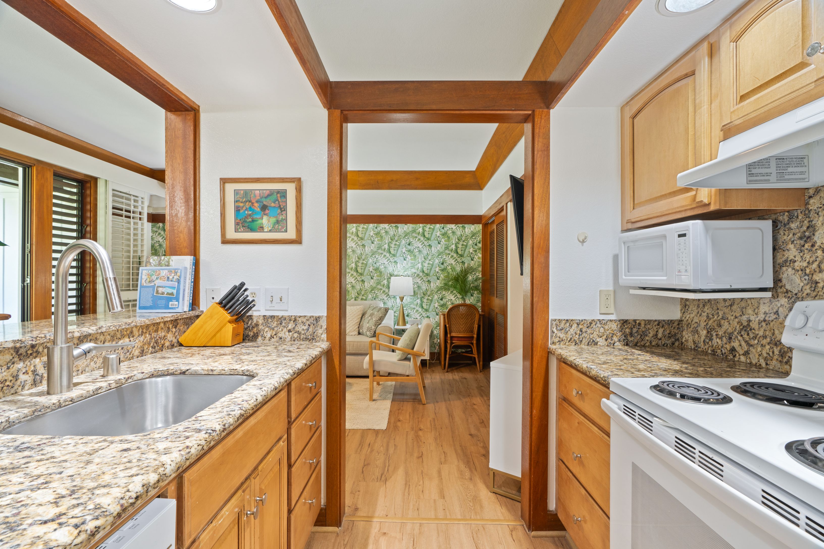 2253 Poipu Road, Unit 419 Koloa, HI 96756 - Photo 15 of 30 a kitchen with granite countertop a sink and a stove top oven