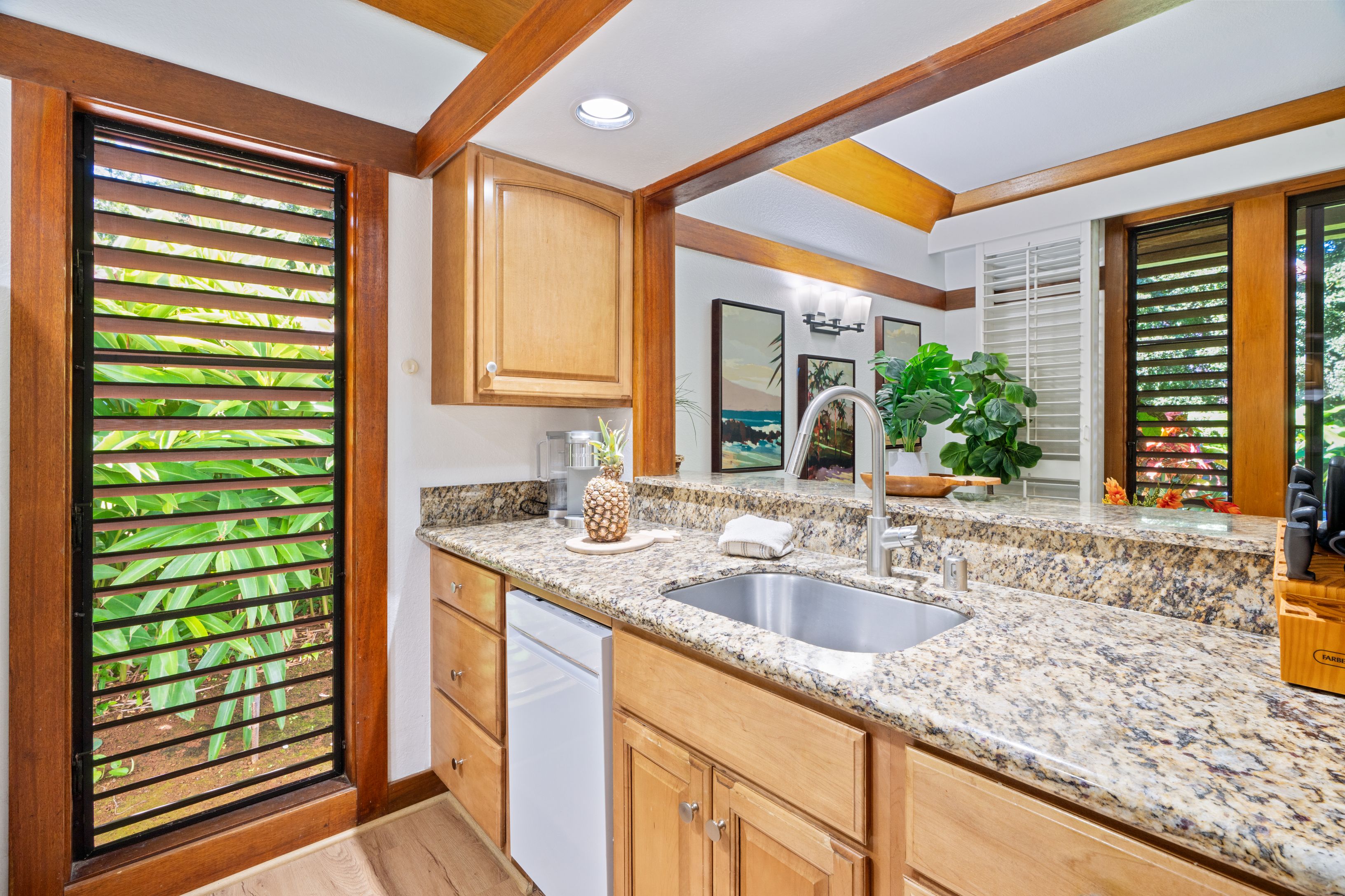 2253 Poipu Road, Unit 419 Koloa, HI 96756 - Photo 17 of 30 a kitchen with granite countertop a sink and a window