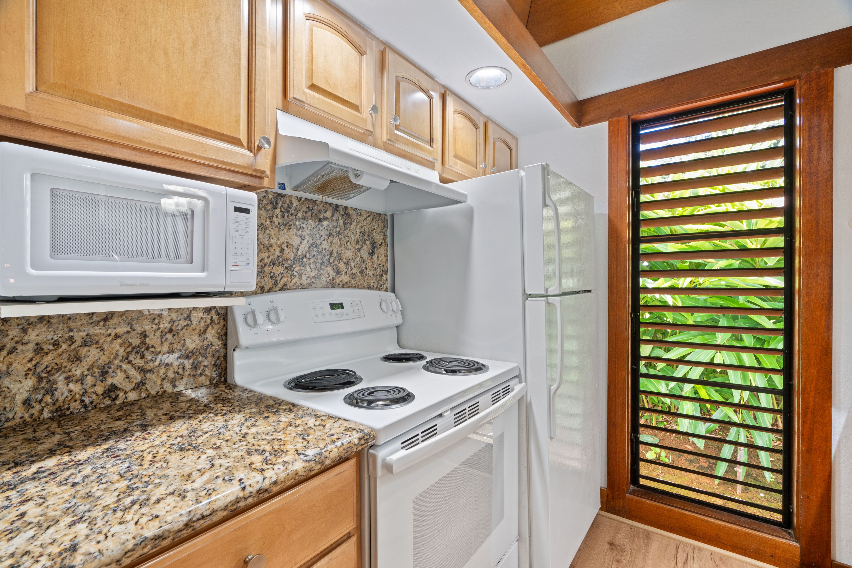 2253 Poipu Road, Unit 419 Koloa, HI 96756 - Photo 18 of 30 a kitchen with a stove and a refrigerator
