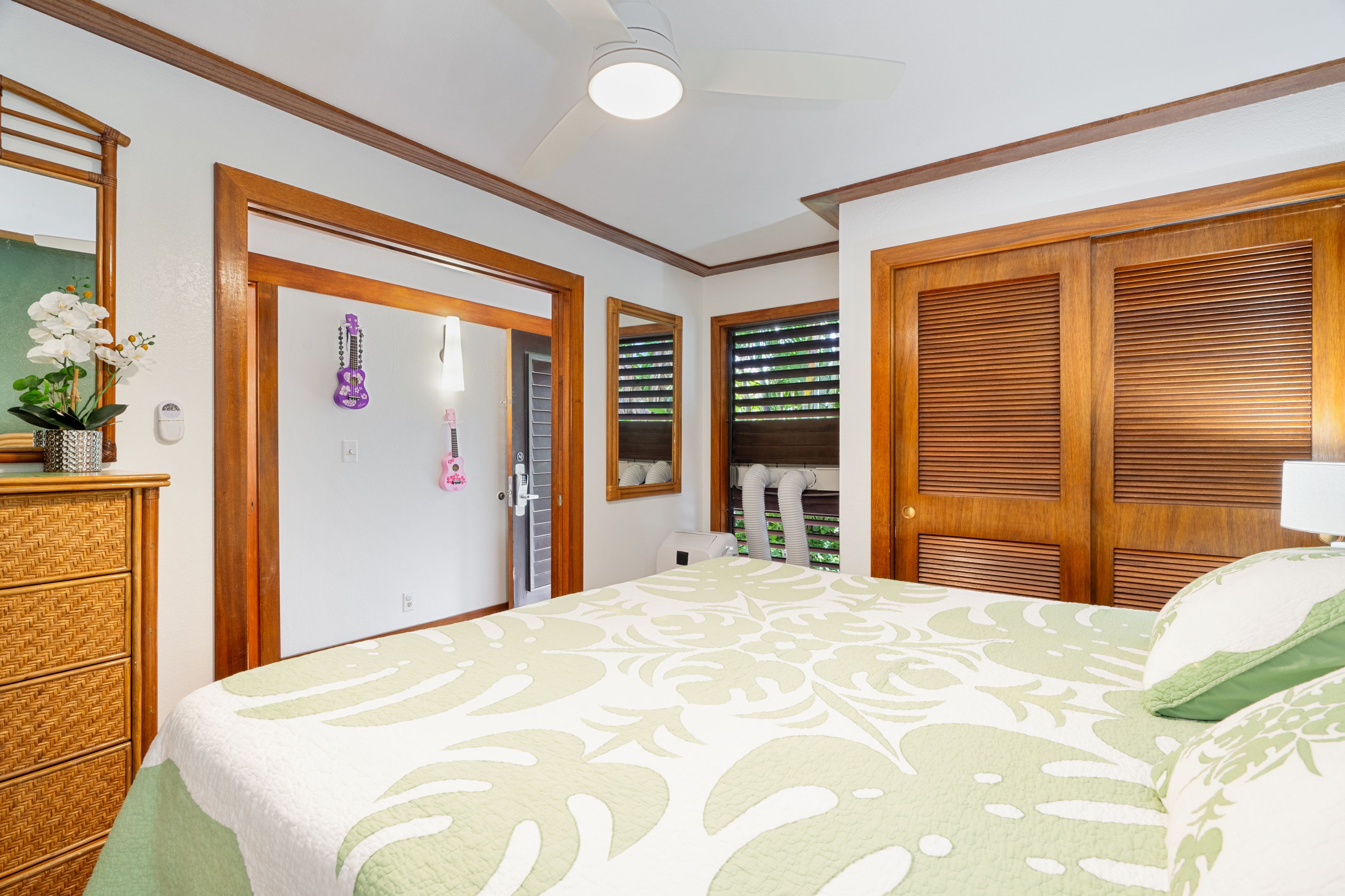 2253 Poipu Road, Unit 419 Koloa, HI 96756 - Photo 20 of 30 a bedroom with a bed and a large mirror